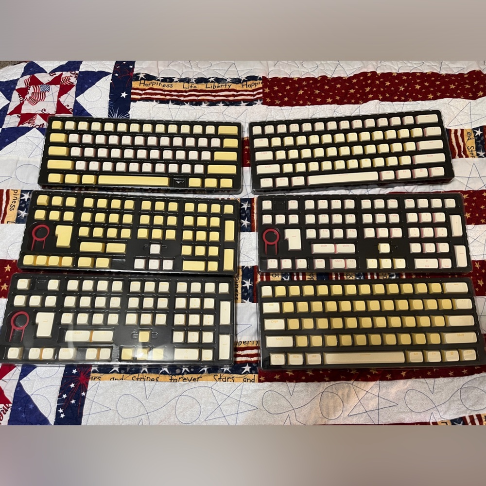 PBT Keycaps from Lava Keys 3 sets pink, and two shades of yellow